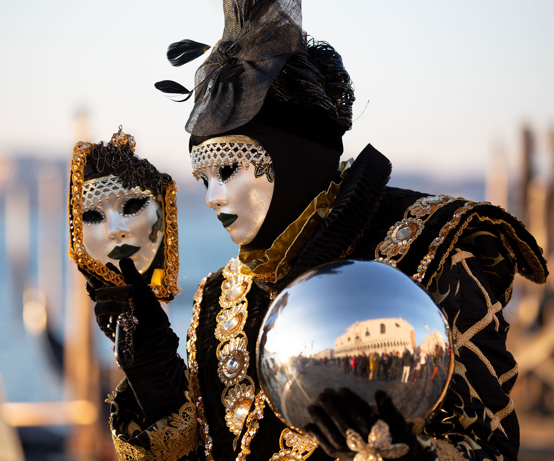 A reveller wearing a mask and a period costume takes part in the Venice Carnival on February 16, 2020-Laura Venezia