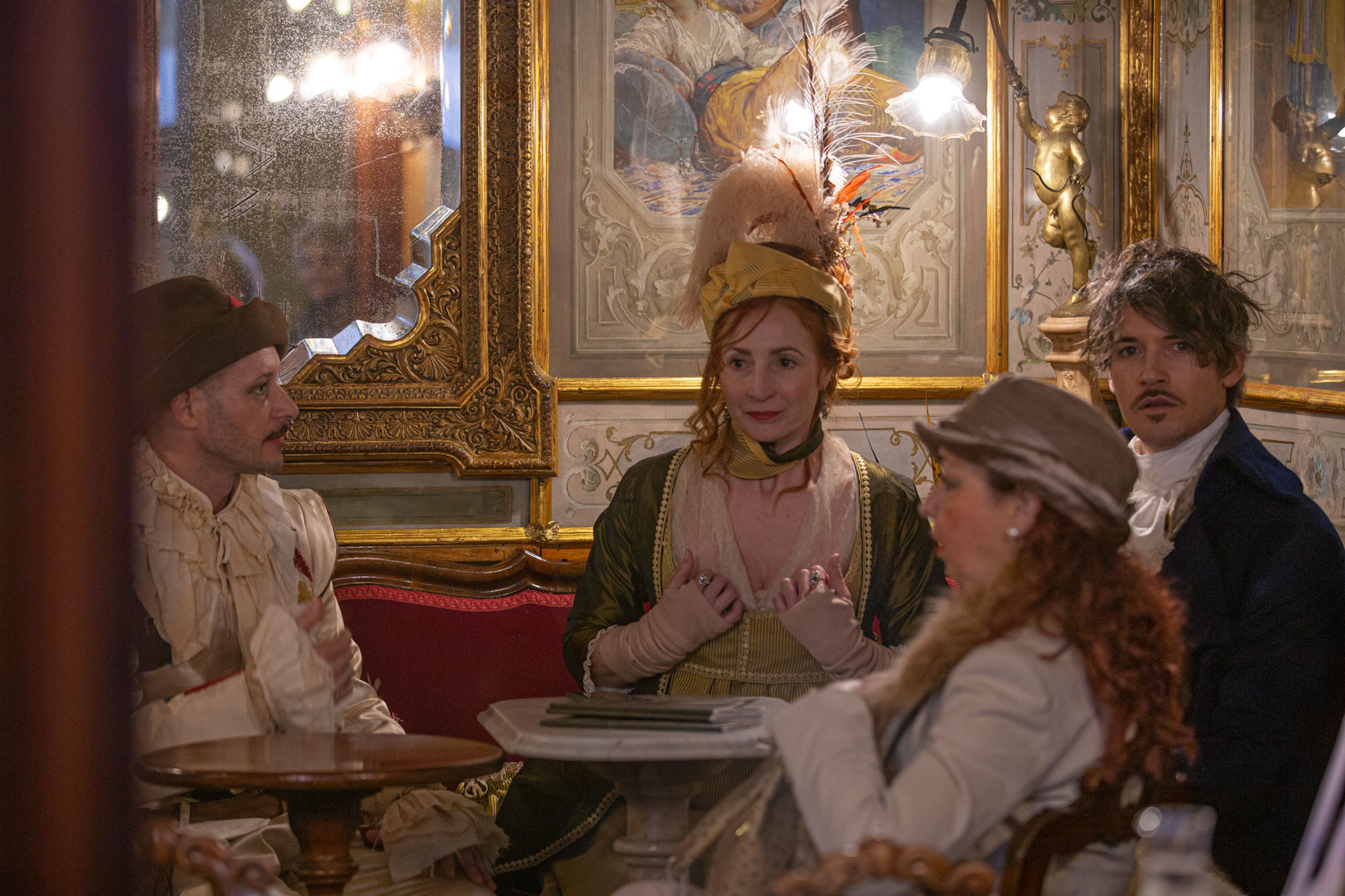  Masked revellers have a coffee break at Florian Cafe in Saint Mark Square. Venice, February 16 2020-Laura Venezia